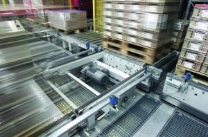 Pallet conveyor uses roller and chain surface to move pallets in production and warehousing environment.