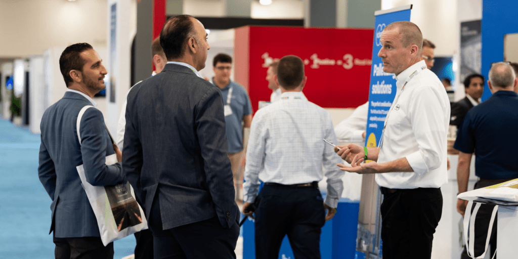 Exhibitor chatting with visitors at tissue world