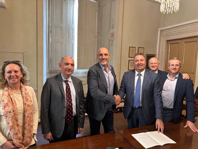 ITA Holding acquires Sipack; Sipack founder and Chief Executive Walter Pacioni (left), shakes hands with ITA Holding shareholder Mauro Celli